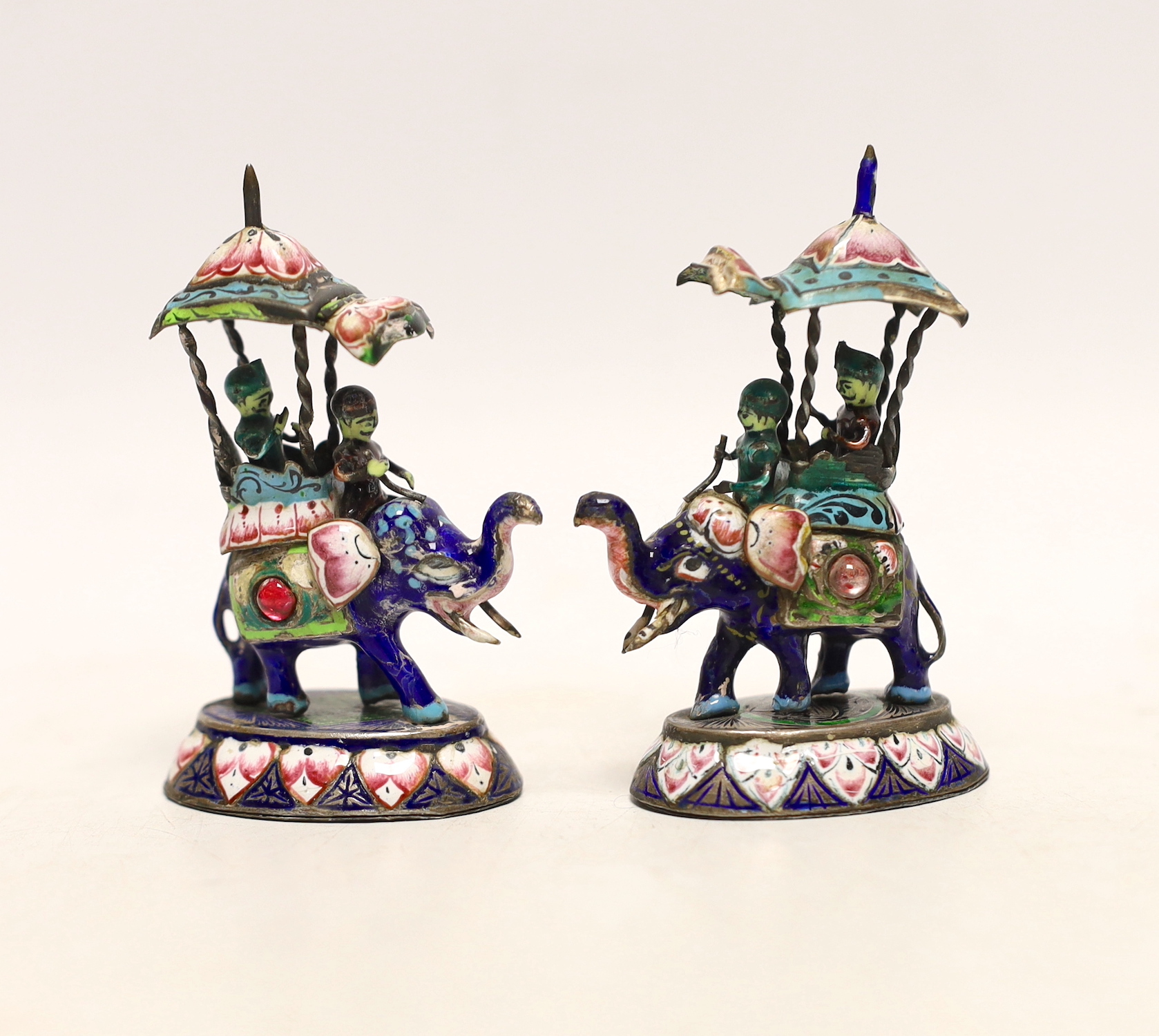 A pair of Indian gilt white metal and polychrome enamel elephants with howdahs, height 77mm.